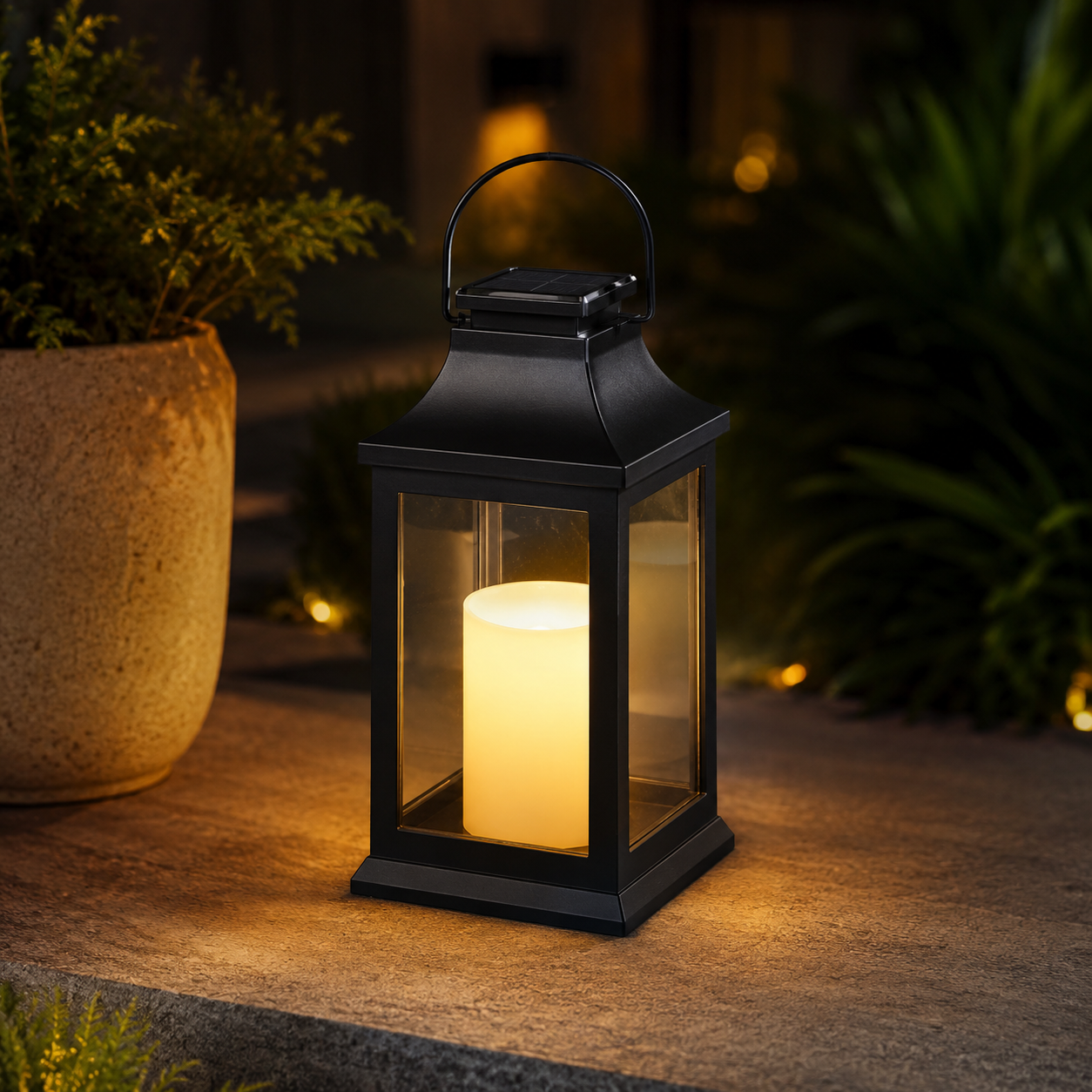 Black solar lantern outdoor light glowing in garden patio at night - image 1
