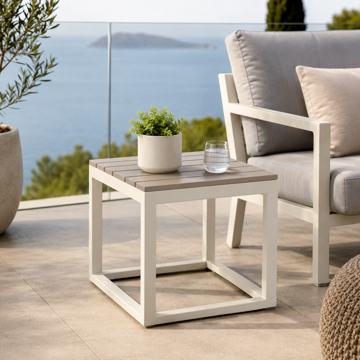 Modern outdoor patio side table beside lounge chair in garden terrace setting - image 1