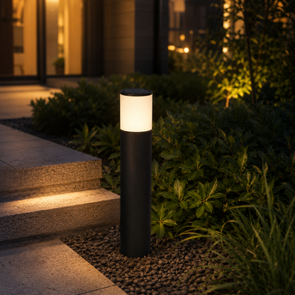 Matte black solar bollard path light glowing beside garden walkway at night - image 2
