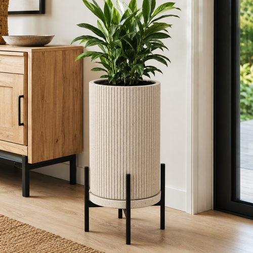 Tall ribbed planter with black metal stand and green plant in modern home - image 1