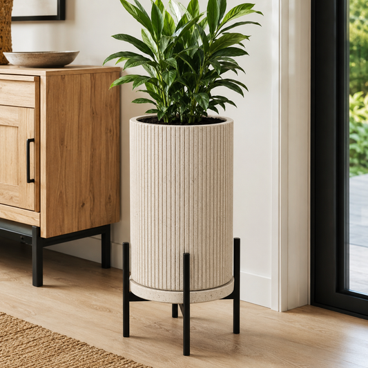 Tall ribbed planter with black metal stand and green plant in modern home - image 1